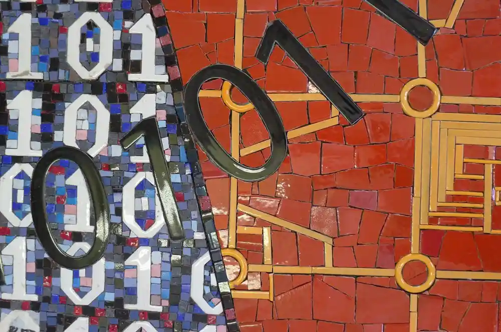 Mosaic artwork featuring black numbers and binary code on vibrant red and blue backgrounds.
