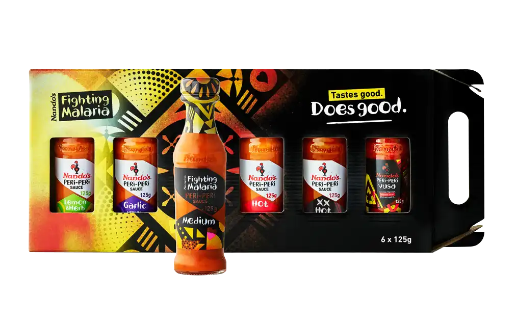 Nando's PERi-PERi sauce gift pack with various heat levels, featuring vibrant, colorful packaging and "Fighting Malaria" branding.