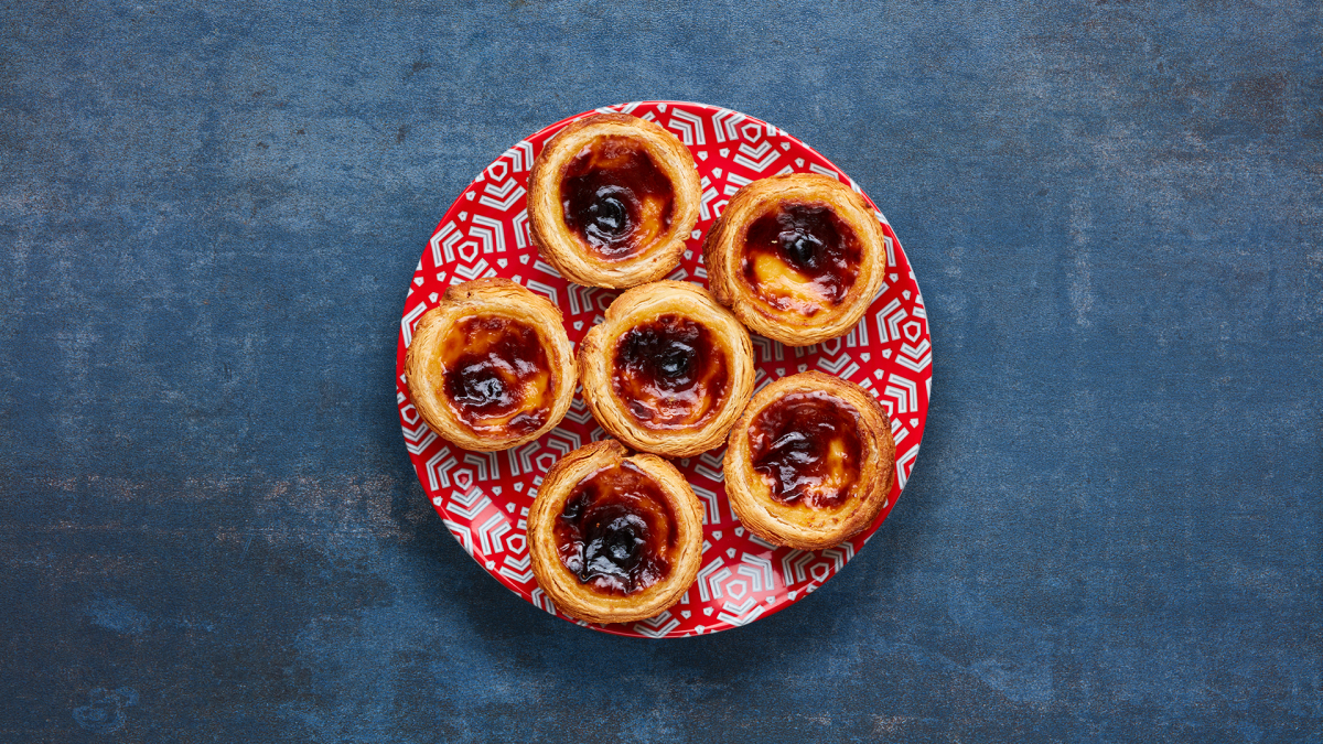 6 Nando's Pastel de Natas on a patterned red plate